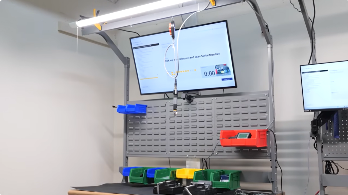 Complete AI assembly workstation with overhead camera, digital SOP dashboard, and tool balancer